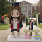 Graduation-themed figurine with a building in the background