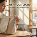 Woman holding a beige bag with a keychain, with text 'Carry Your Story' in the background.