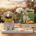 Brick-built dog sculpture with a photo of a real dog on an easel, set against a blurred outdoor background.