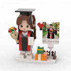 Graduation-themed figure with a gift, flowers, and a scroll, set against a white background.