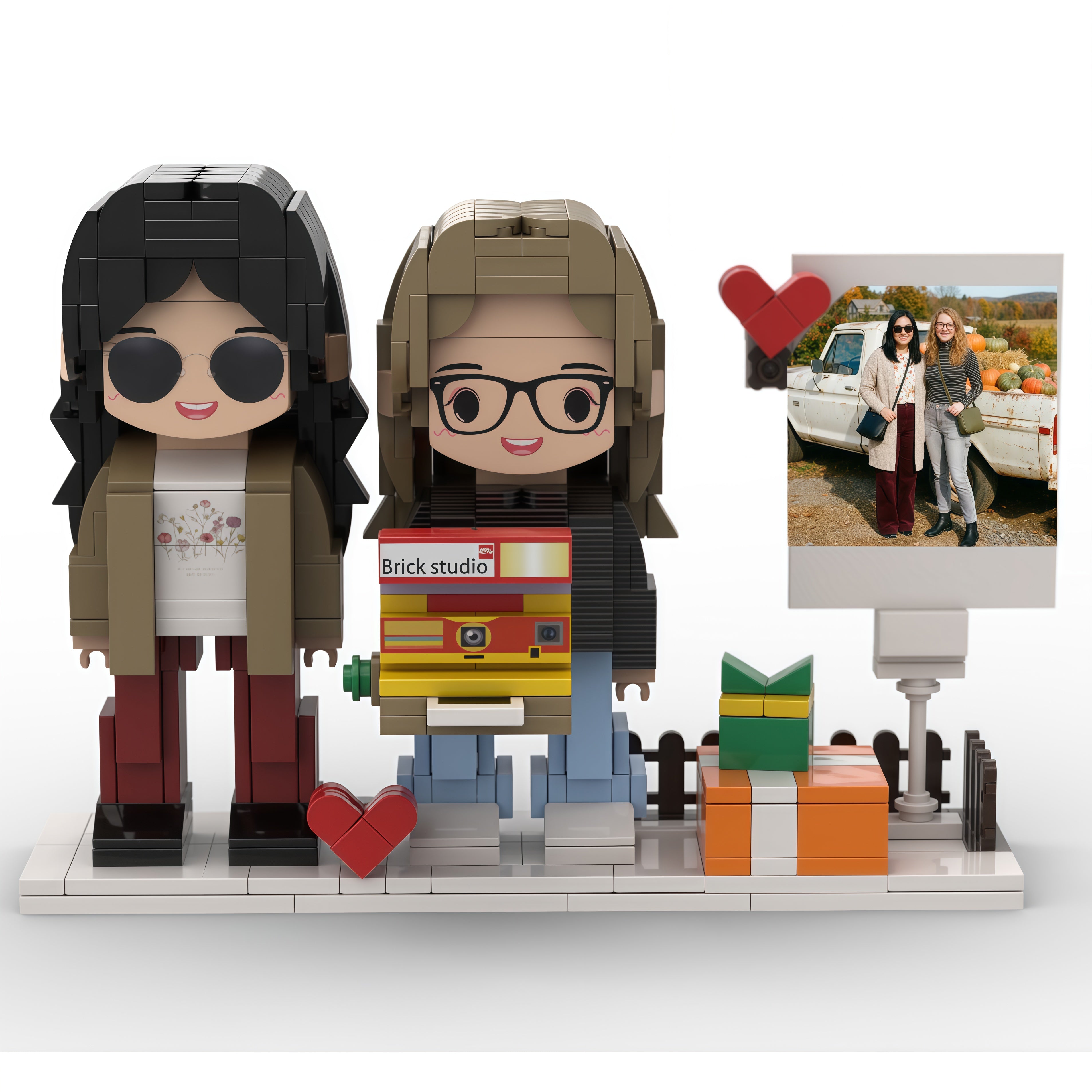 Two brick figures of people with accessories on a white background, with a smaller inset photo frame.
