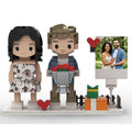 Brick figure of a couple with a heart and a photo frame on a white background